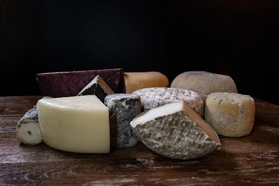 A hand-selected cheese ready to be boxed for a subscription