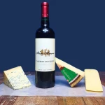 a bottle of cabernet sauvignon and some cheeses