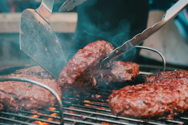 The Ultimate Wine and Food Pairing Guide 5 Burgers cooking on a barbecue