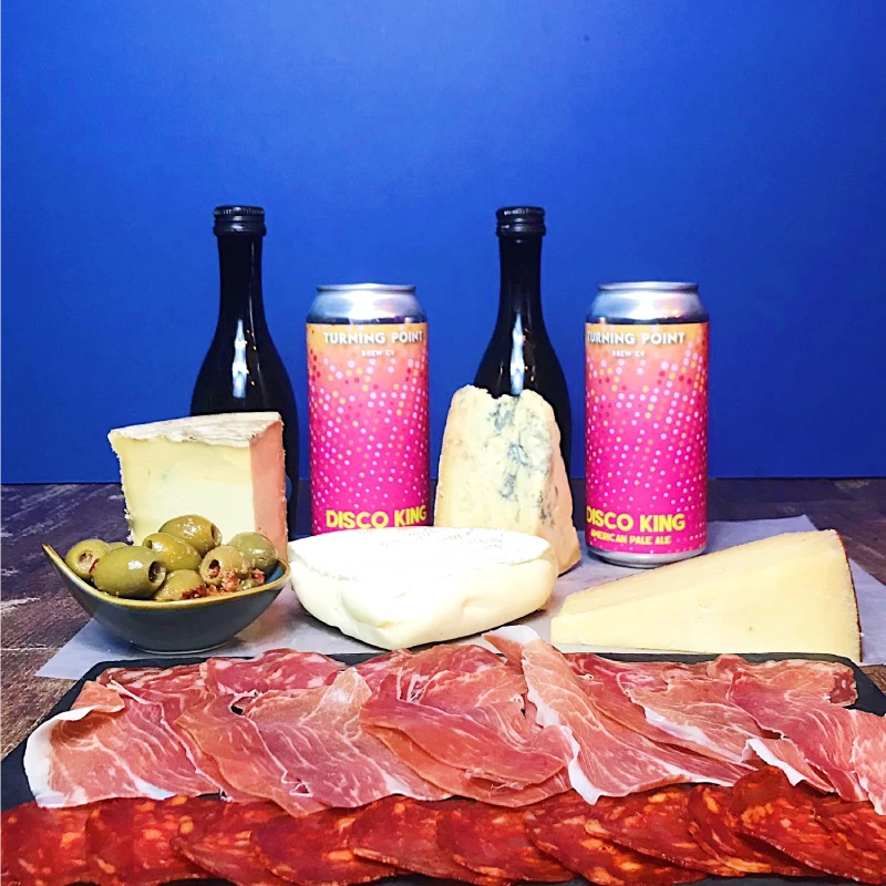 How to Make a Charcuterie Board: A Cheesemonger's Guide 3 Serrano ham and chorizo on slate with cheeses and olives