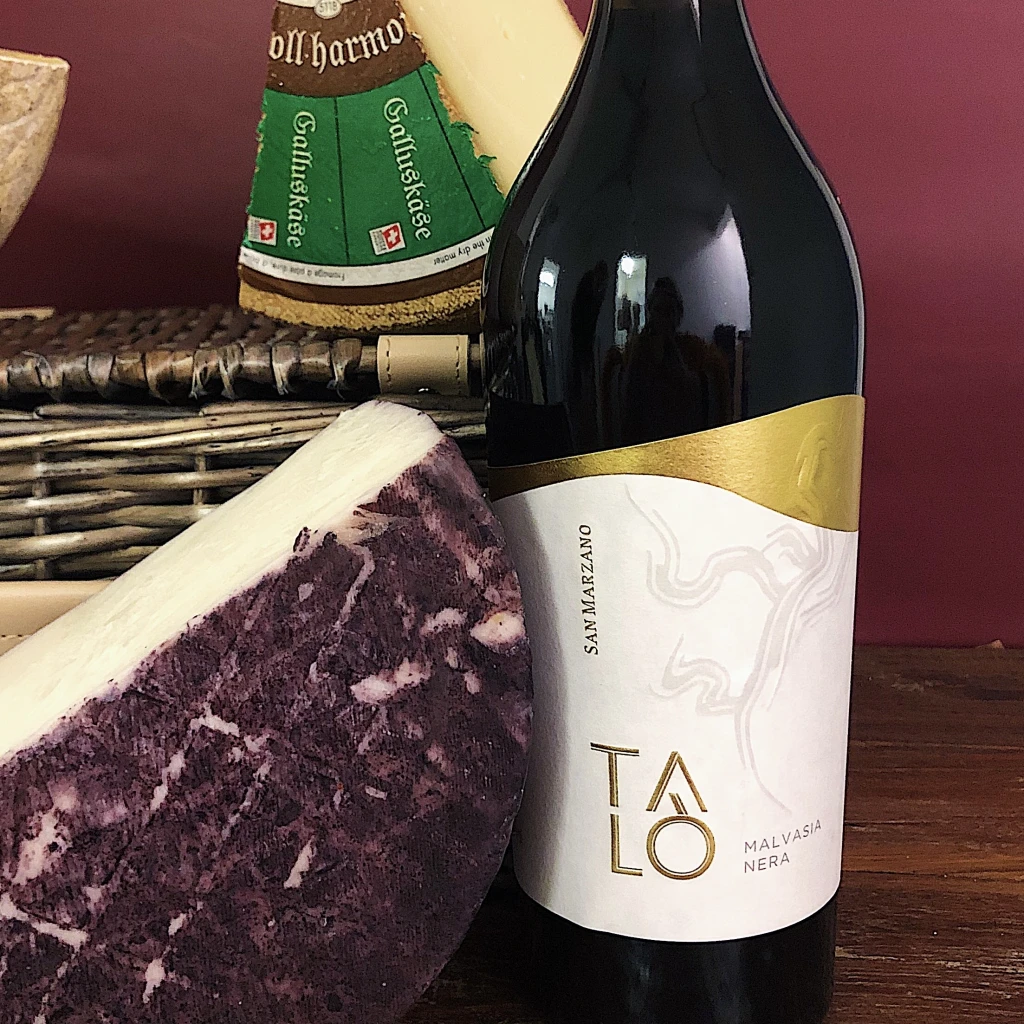 10 Hard Cheeses Everyone Should Know 26 Murcia al Vino Drunken Goat hard cheese with a bottle of Talo Malvasia Nera