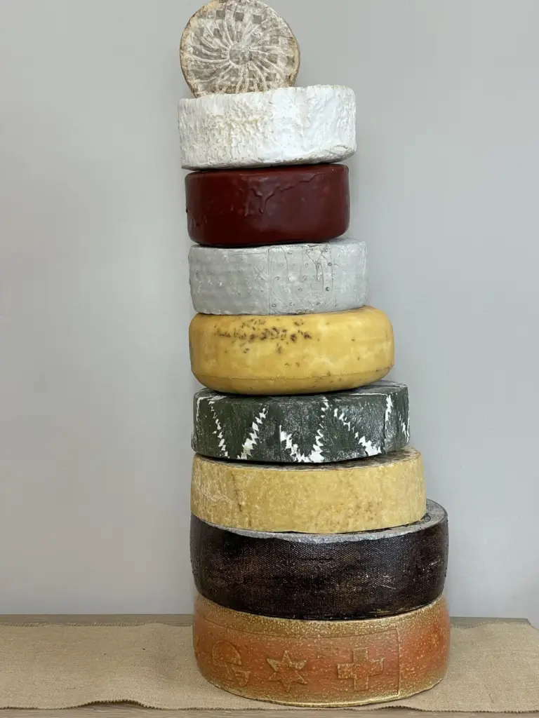 Cheese Wedding Cakes: How Much Cheese, Which Cheeses and How It Works 3 An eight-tier cheese wedding cake before dressing, showing the different wheels